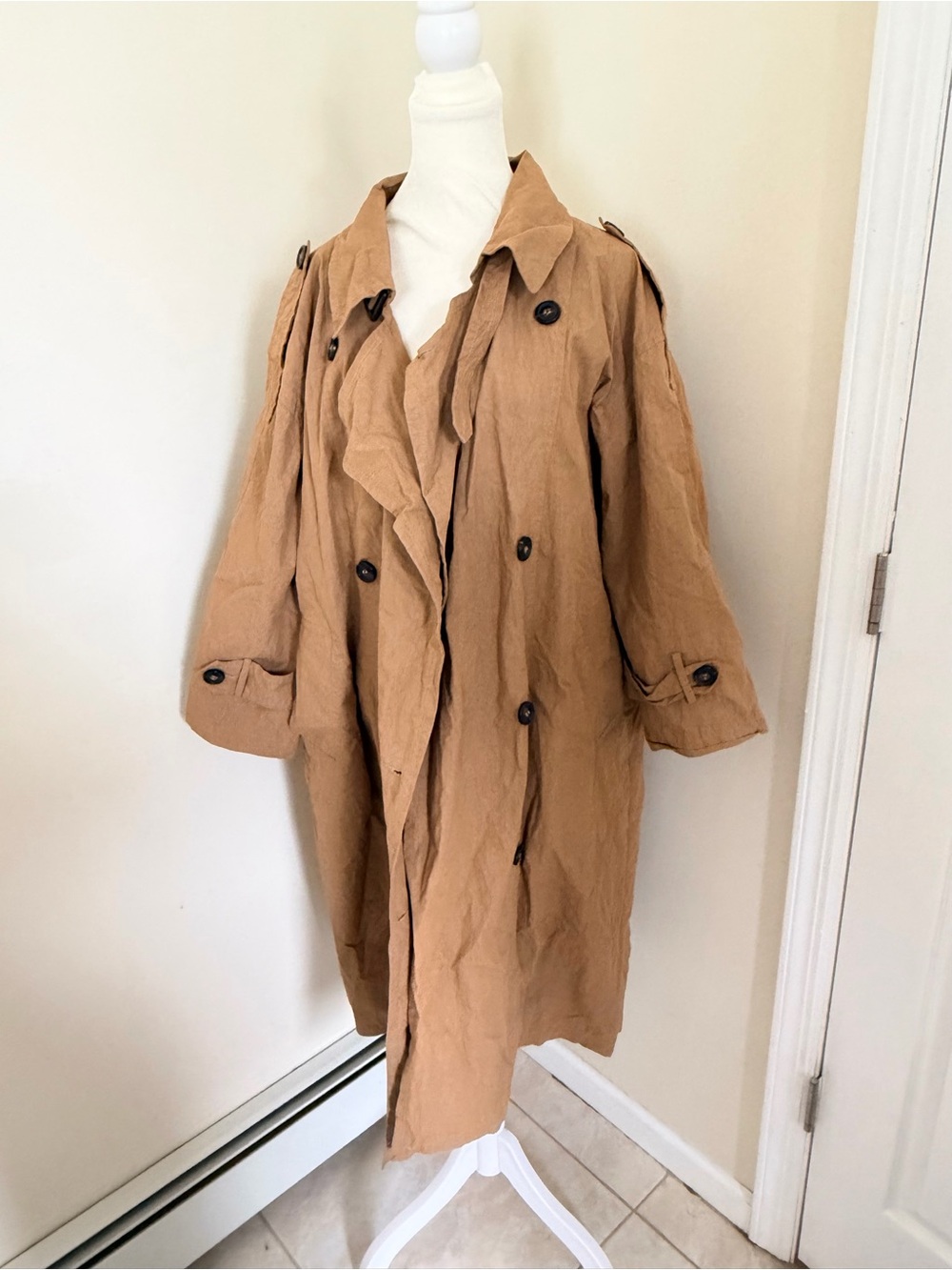 taupe trench coat features a double-breasted button closure long